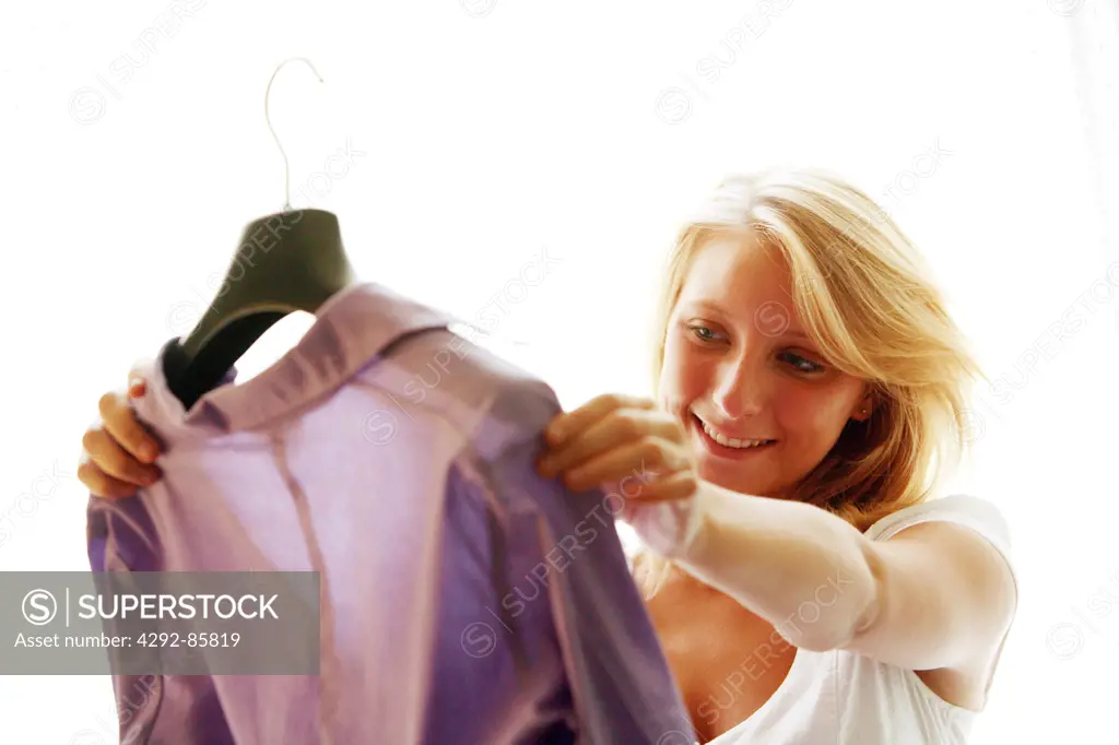 Woman holding blouse