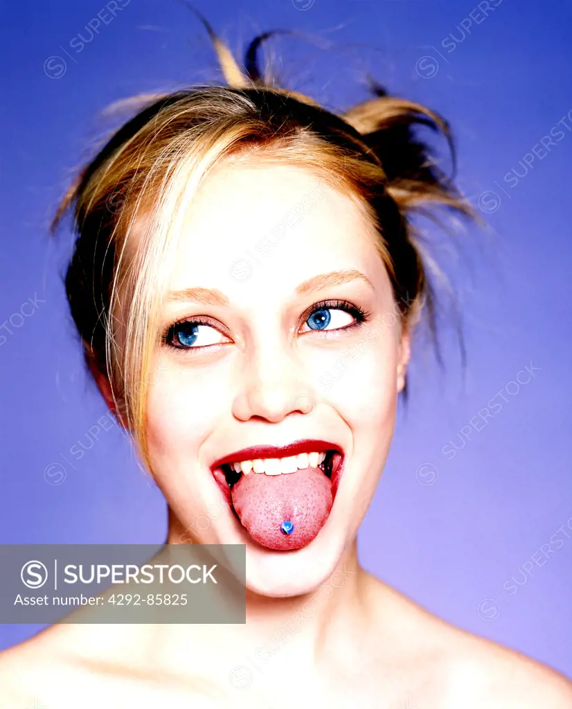 Woman sticking out pierced tongue