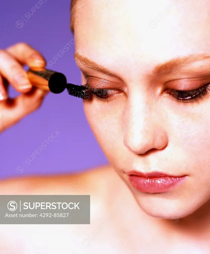Woman putting mascara on