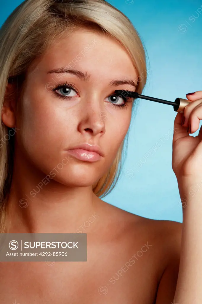 Woman putting mascara on