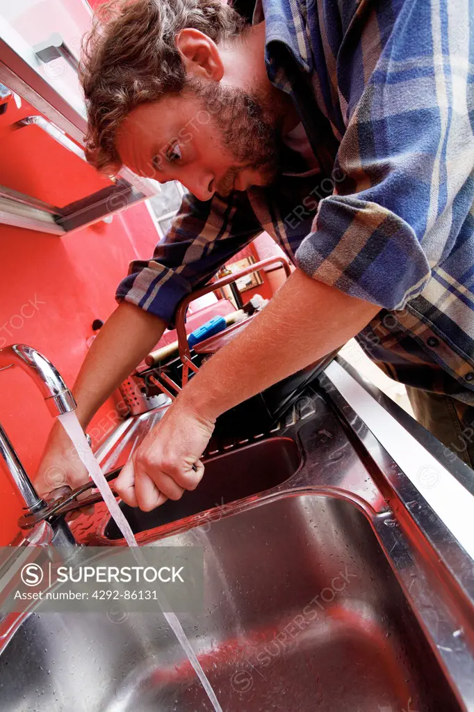 Plumber repairing sink