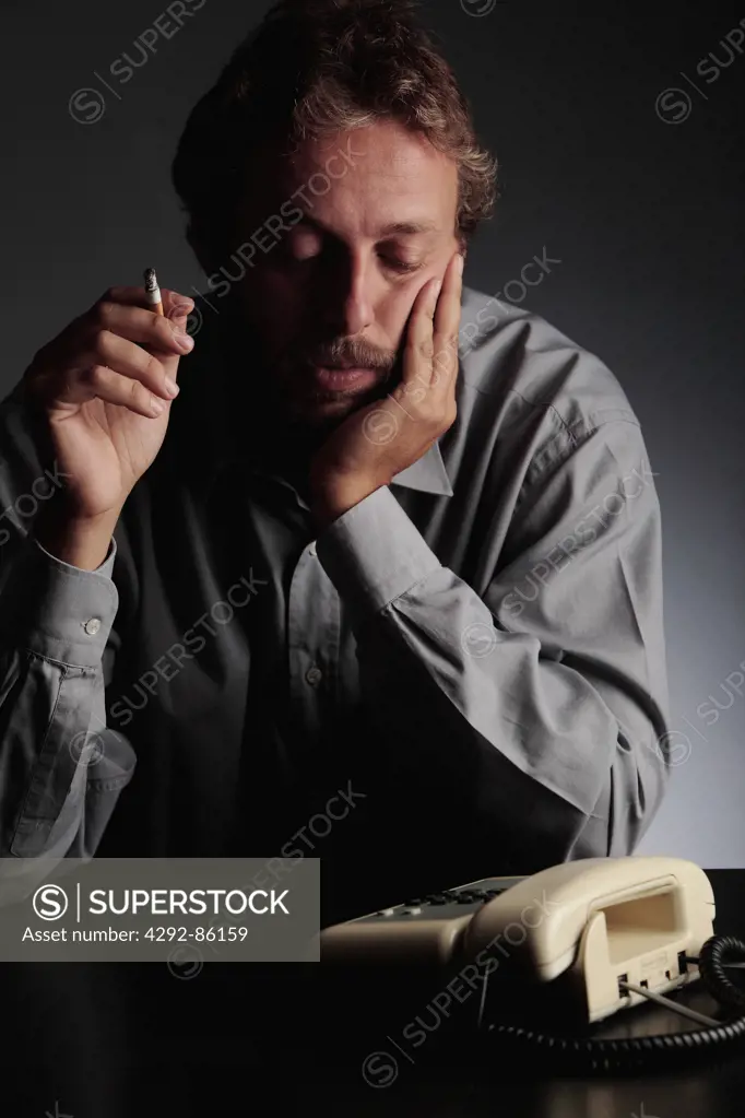 Man looking at telephone