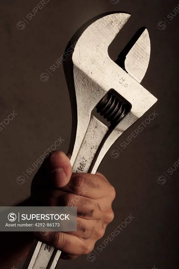 Close up of man's hand holding wrench