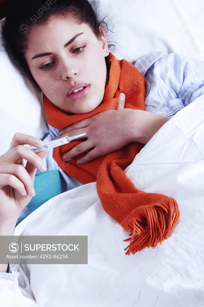 Woman looking at thermometer