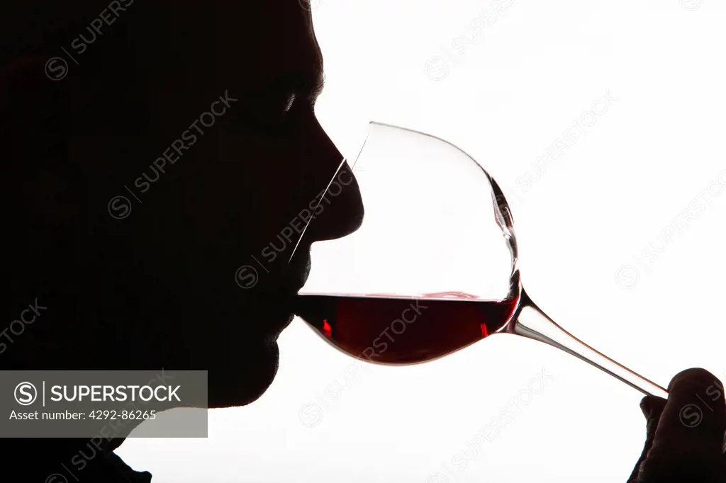 Man profile drinking a glass of red wine