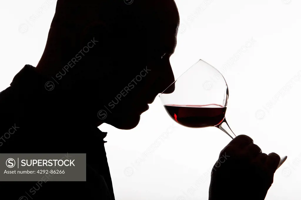 Man profile drinking a glass of red wine