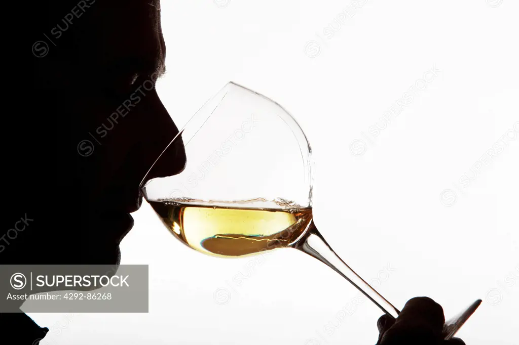 Man profile drinking a glass of white wine