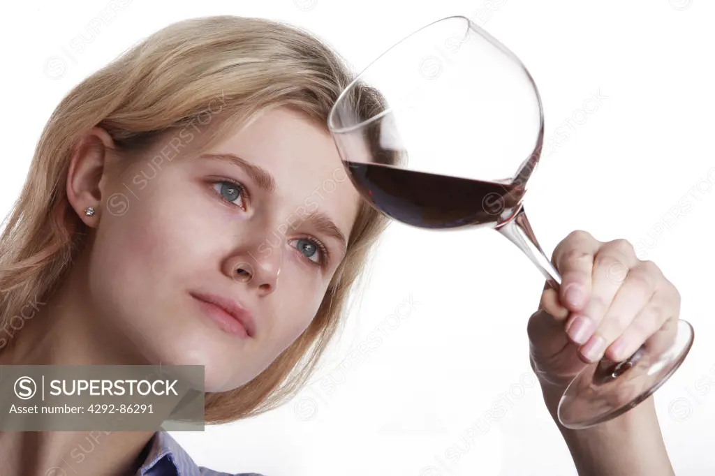 woman looking at red wine glass
