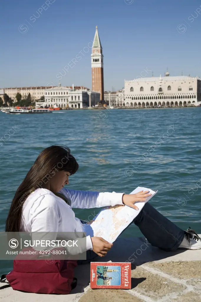 Italy, Venice. Tourist reading map