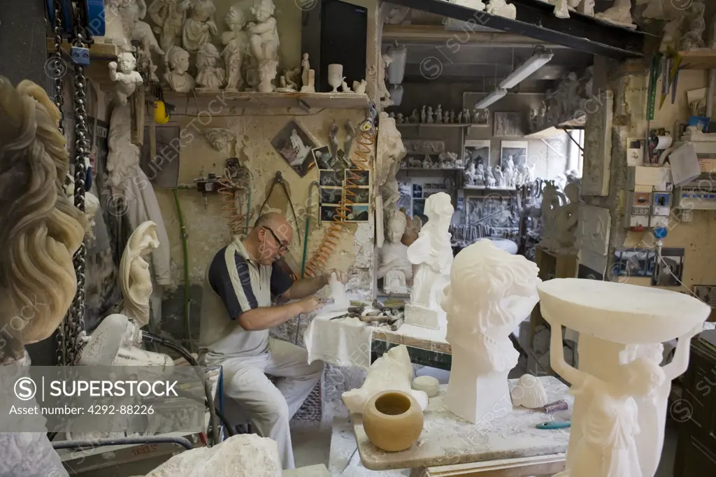 Italy, Tuscany, Volterra. Man working with alabaster