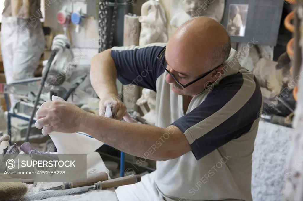 Italy, Tuscany, Volterra. Man working with alabaster