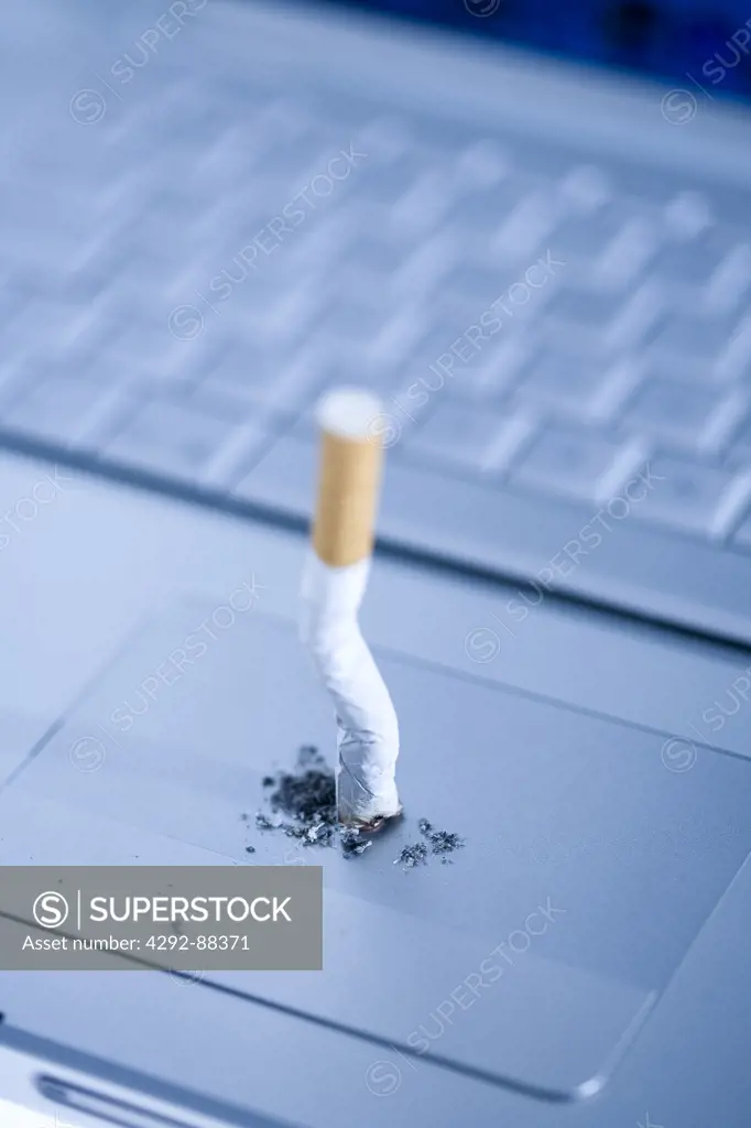 Cigarette butt on laptop