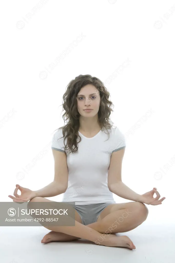 Studio shot of young woman doing yoga