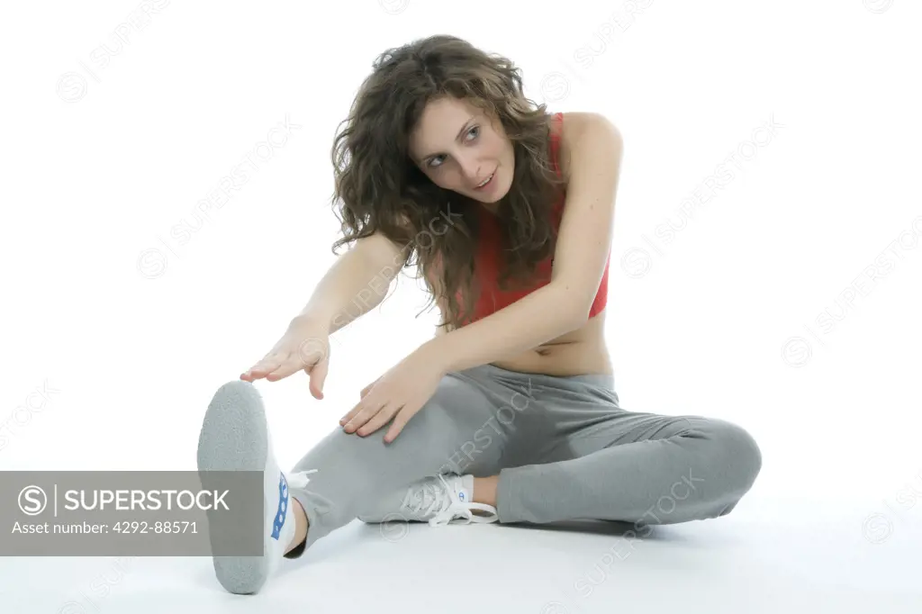Studio shot of young woman exercising