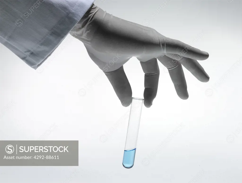 Hand of scientist with test tube -close up