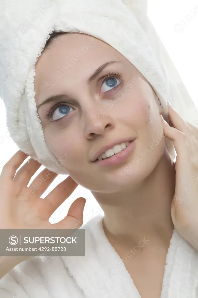 Portrait of a young woman with a towel wrapped around her head
