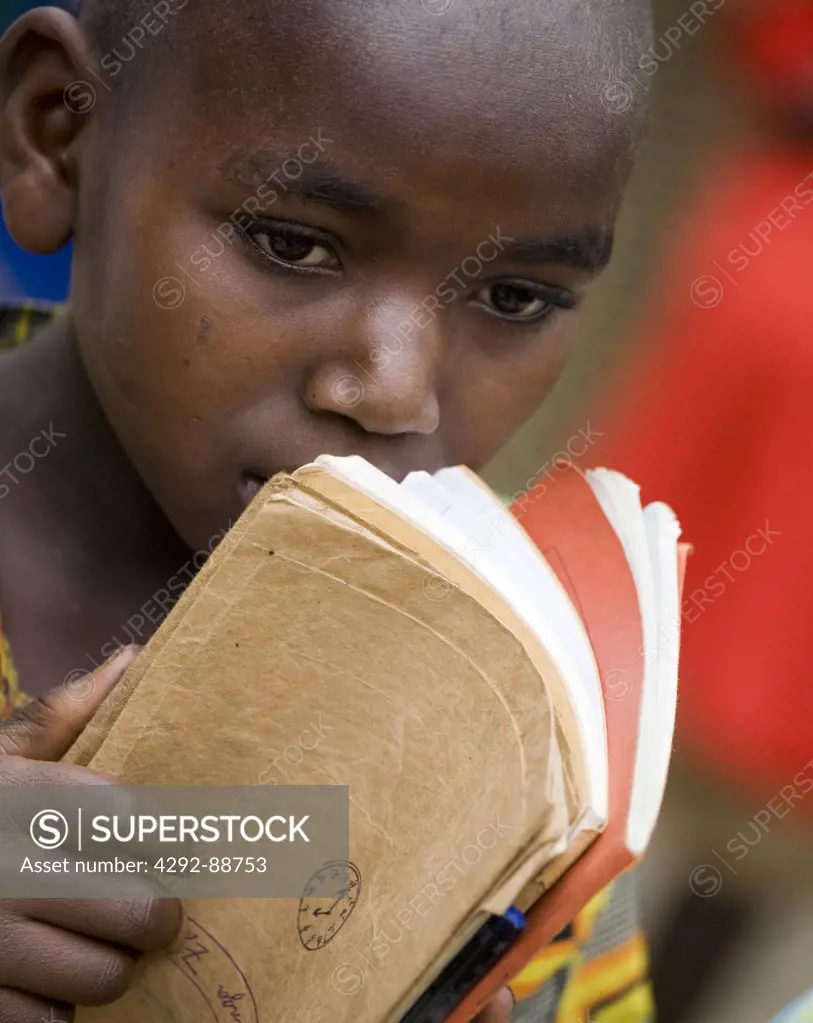 Africa, Burundi, boy holding books