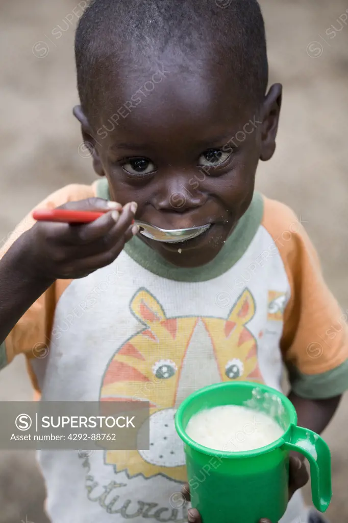 Africa, Burundi, boy eating