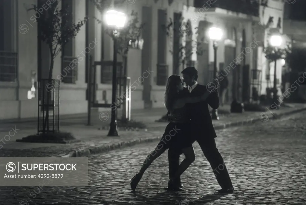Argentina, couple dancing tango on San Telmo street in Buenos Aires at night