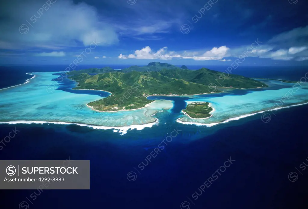Aerial view of Huahine Island with surrounding coral reefs and lagoons in French Polynesia