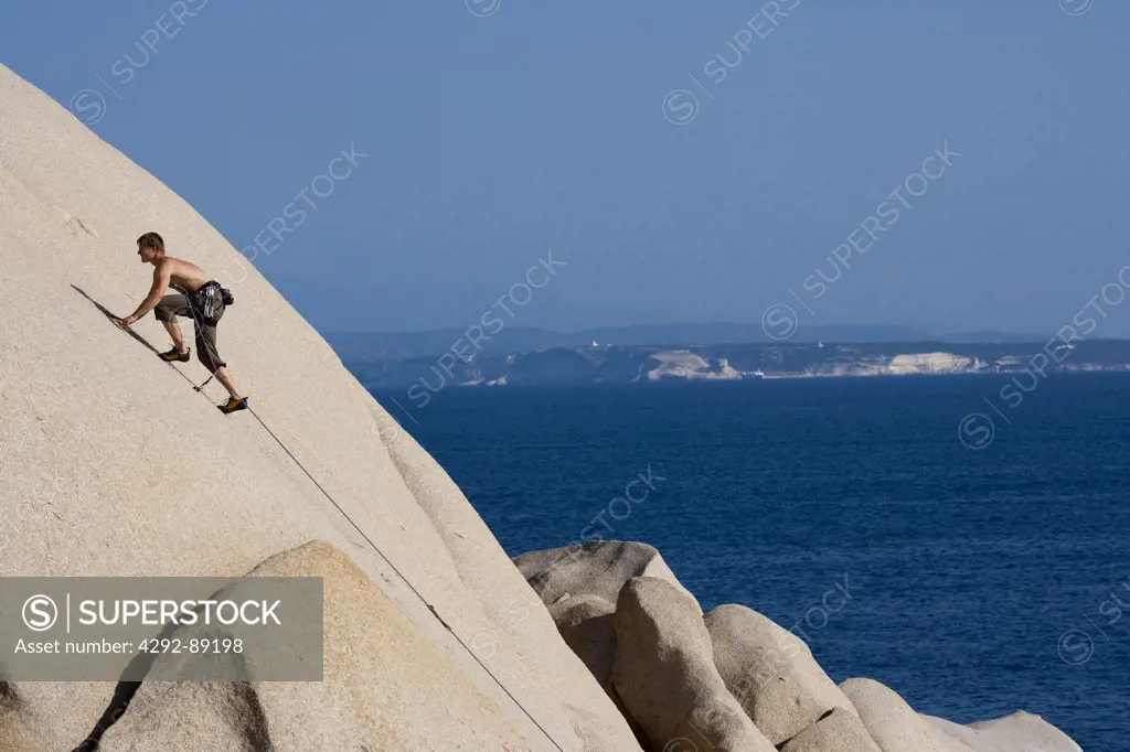 Italy, Capo Testa, Sardinia, free climber on the rocks