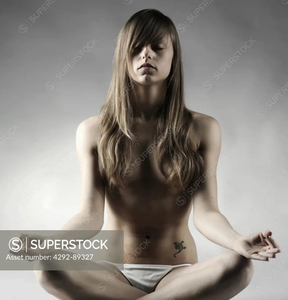 Female in lotus position practicing yoga