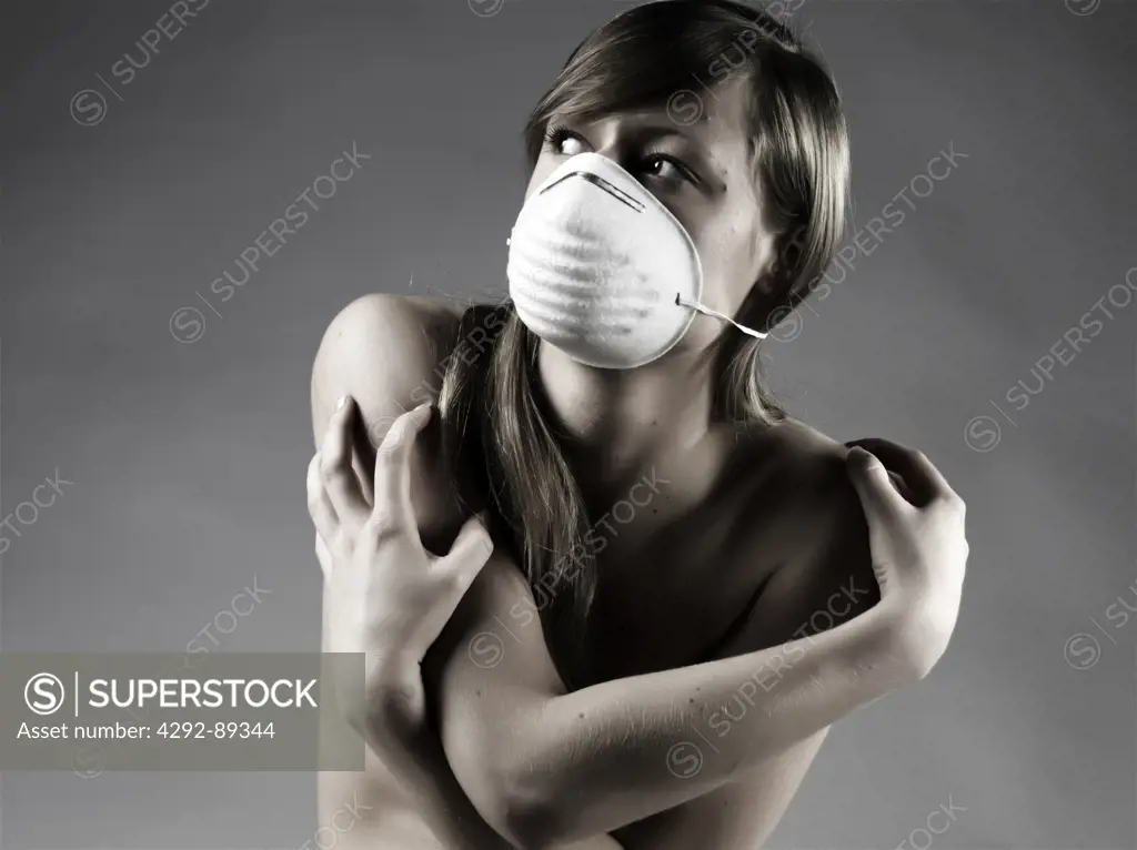Studio shot of woman wearing flu mask