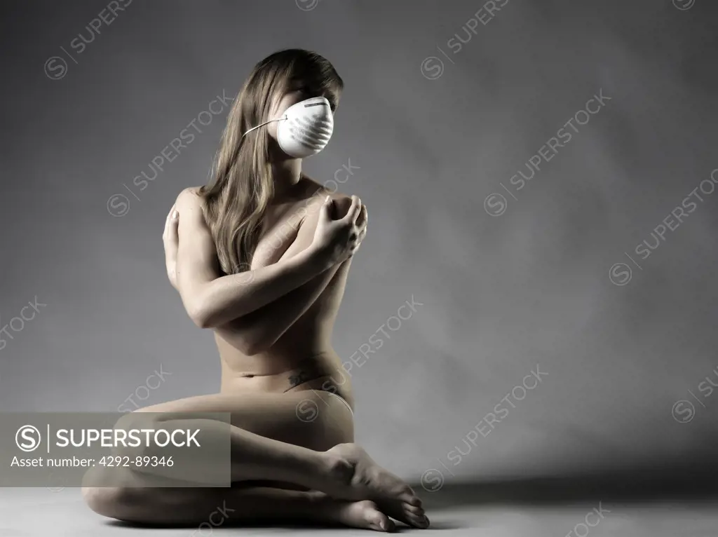 Studio shot of woman wearing flu  mask