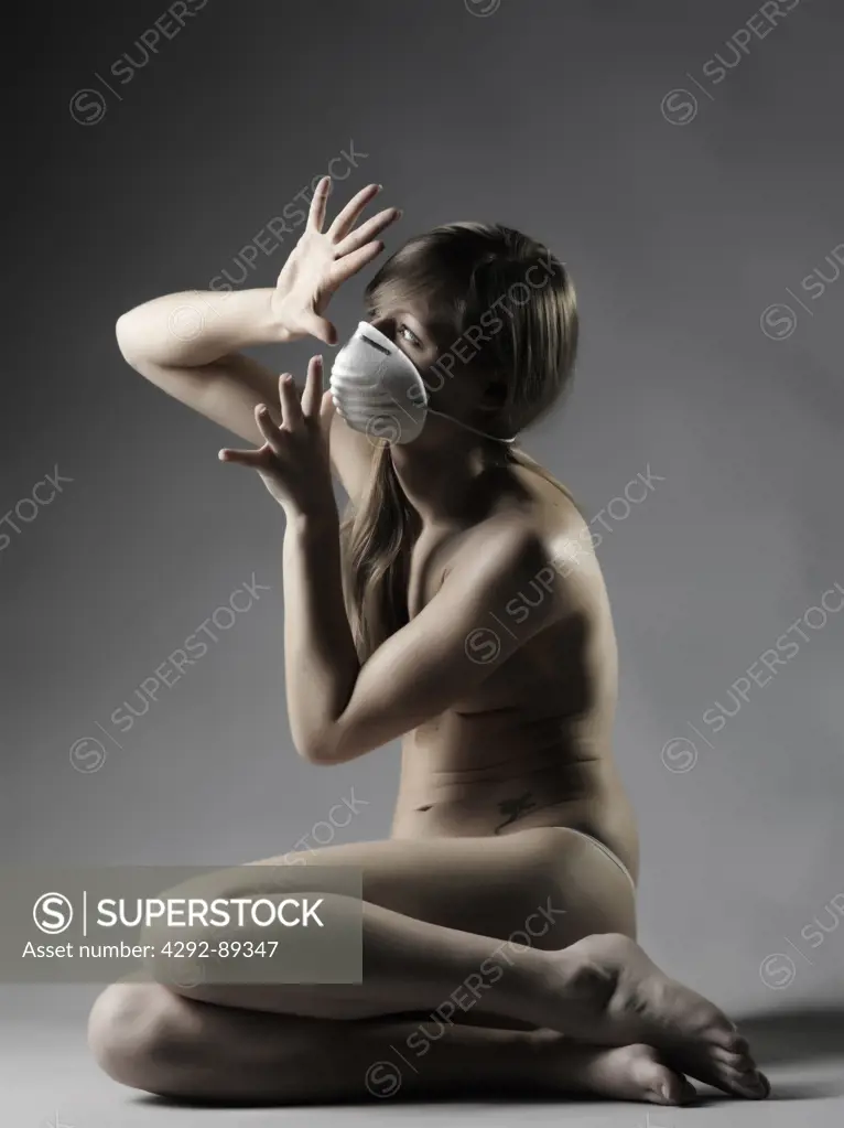 Studio shot of woman wearing flu mask