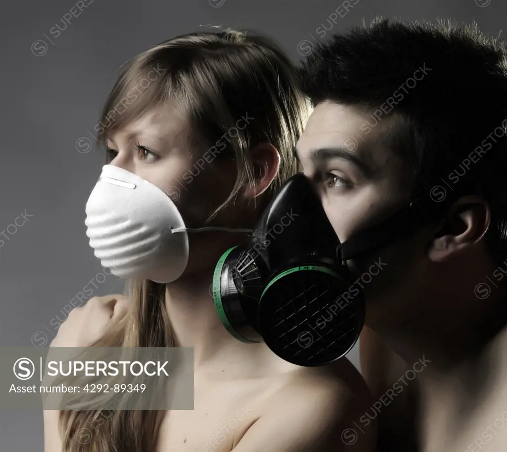 Man and woman wearing flu and gas mask