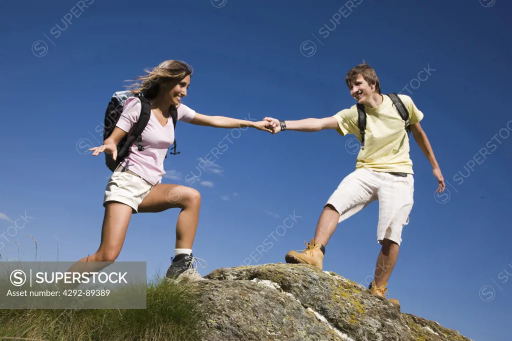 Man and woman rock climbing