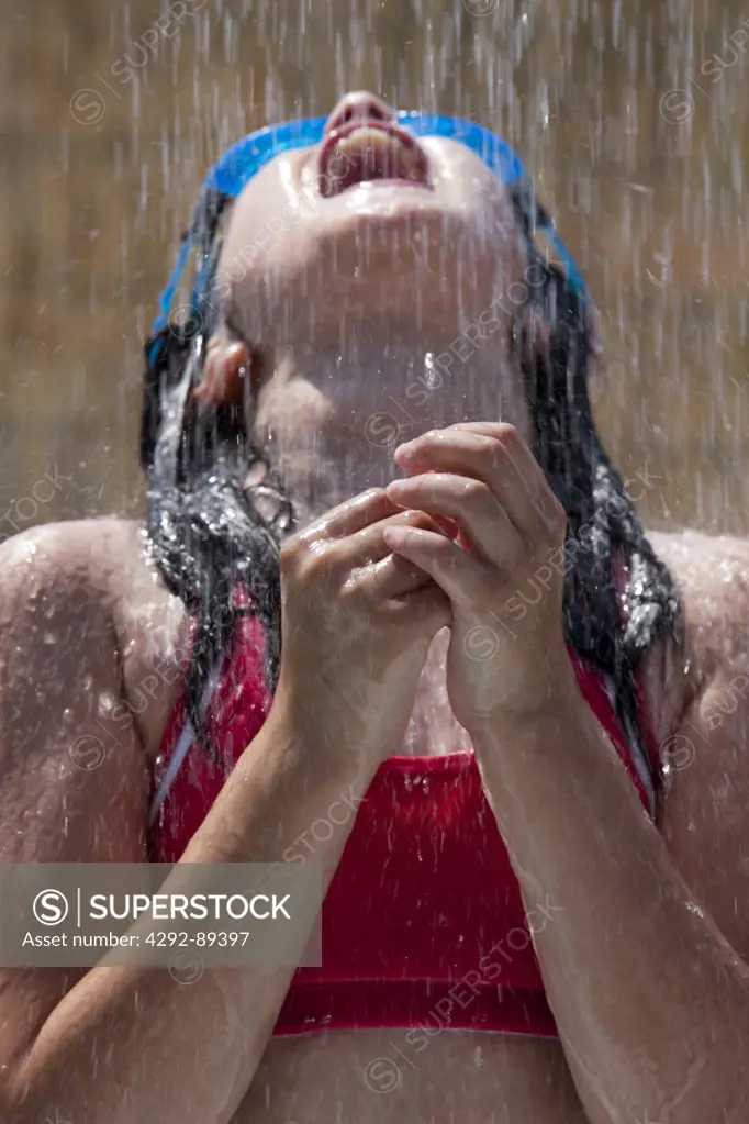 Close up of girl under shower, outdoors