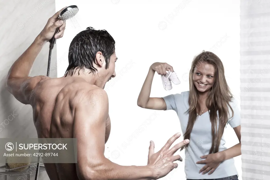 Woman announcing pregnancy at husband under the shower