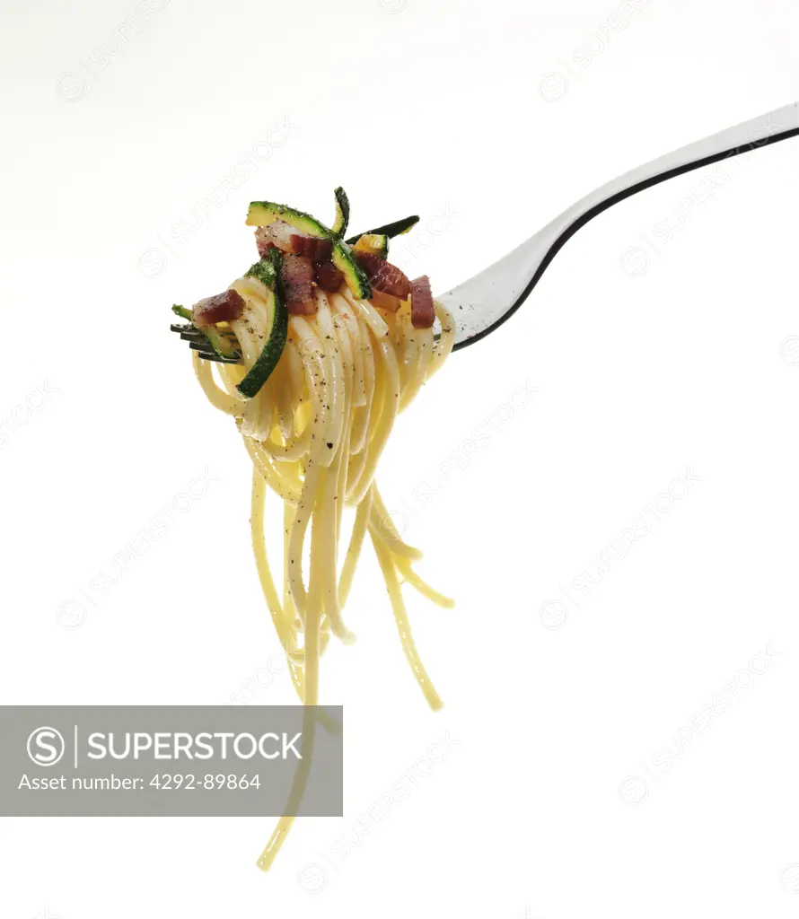 Fork with spaghetti, zucchini and bacon