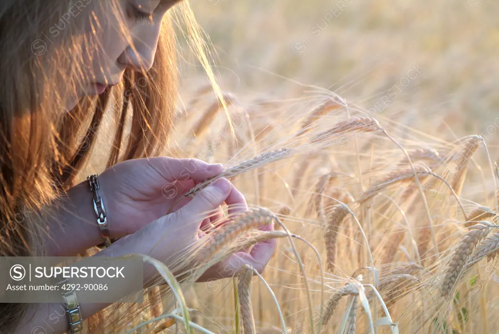Girl holding wheat plant