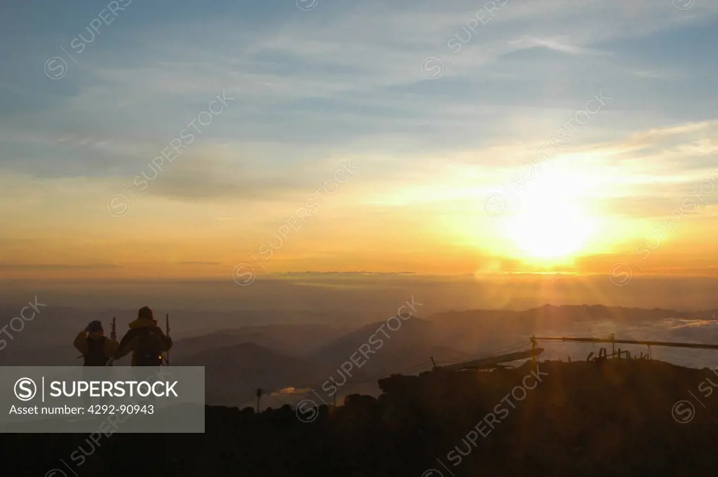 Japan, two climbers on Fuji mountain at sunrise