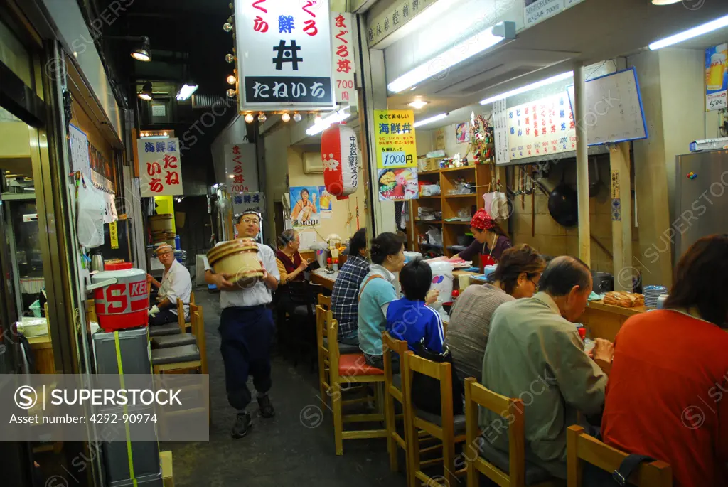 Japan, Tokyo, people sitting at a restaurant at night