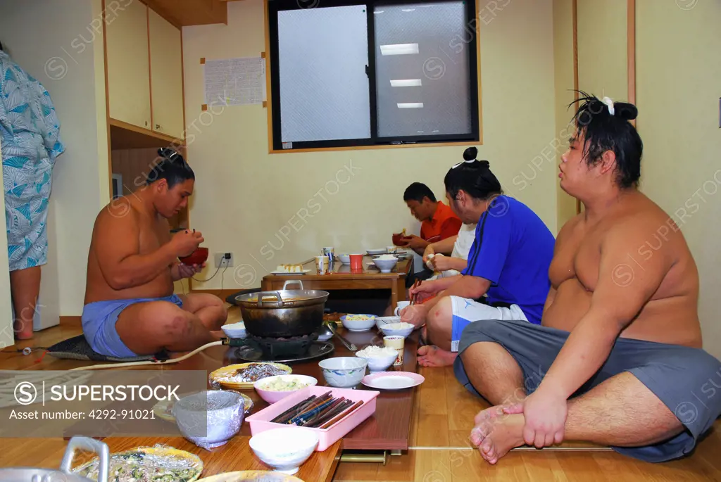 Japan, Tokyo, Sumo wrestlers at lunch after a traning session