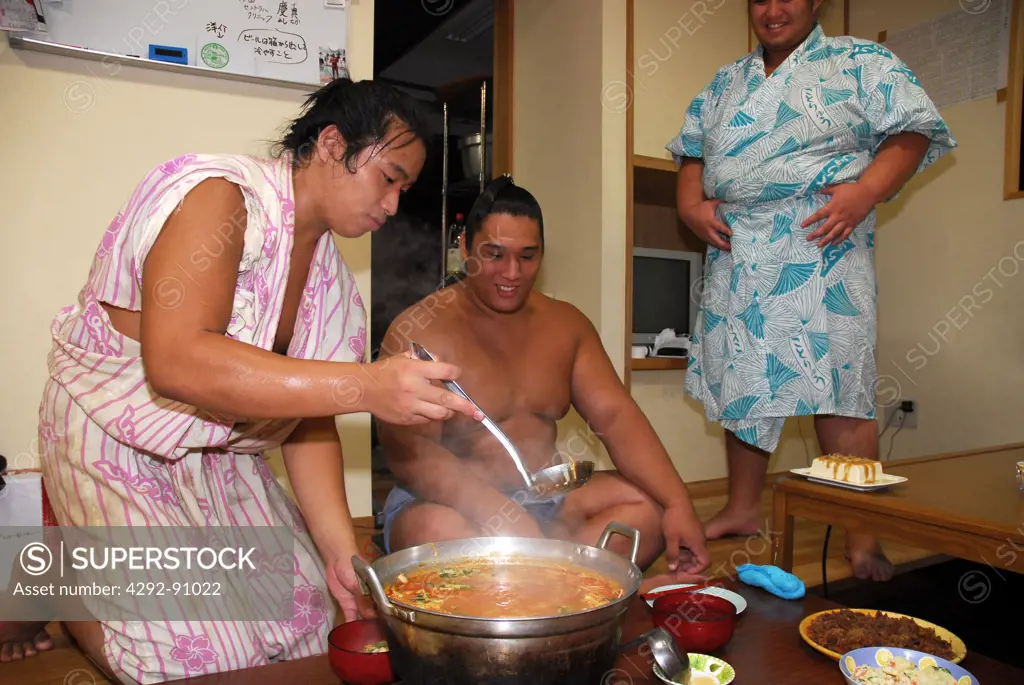 Japan, Tokyo, Sumo wrestlers at lunch after a traning session
