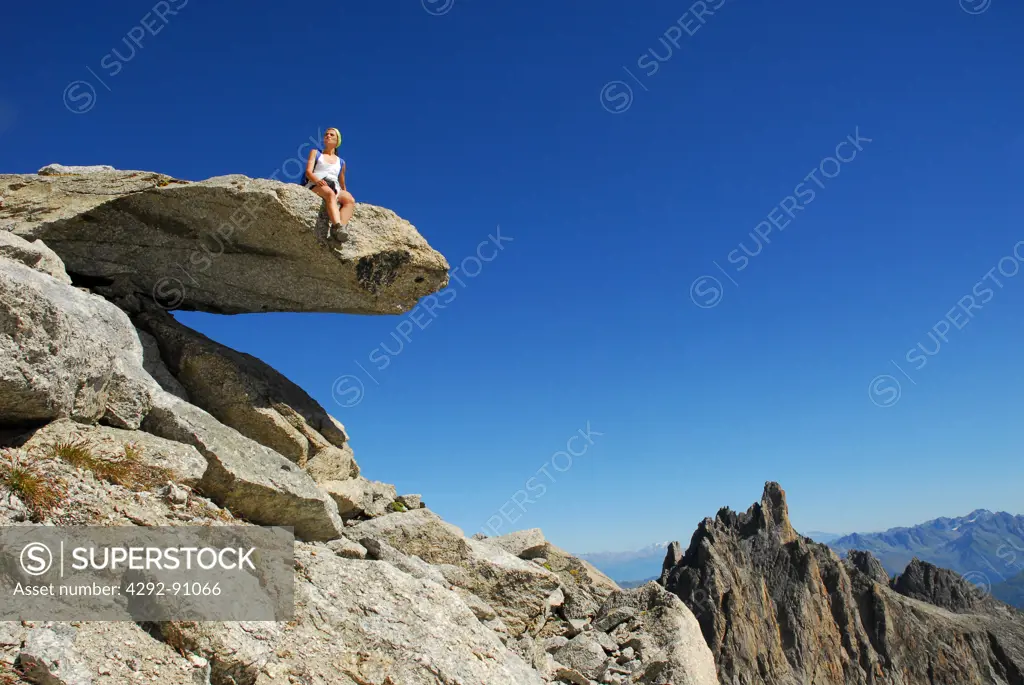 Switzerland, Hiker Sitting on Rock, Looking Landscape.