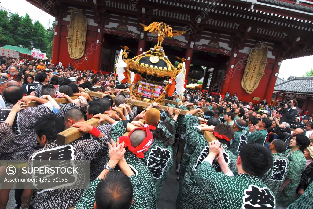 Japan, Honshu, Tokyo. A crowd of worshippers carrying a shrine into the Asakusa Kannon Temple