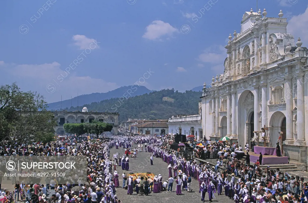 Antigua, Guatemala, During Easter Holy Week procession, members of religious brotherhood shoulder float bearing religious statues