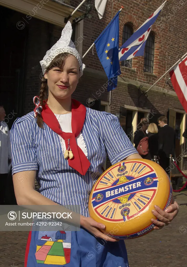 Europe, Netherlands, North Netherlands, Alkmaar, Cheese Market , girl dressed in dutch costume holding cheese