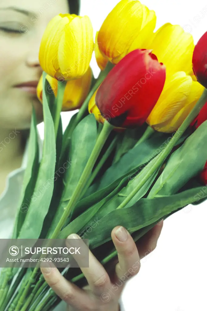Woman smelling a bouquet of artificial flowers