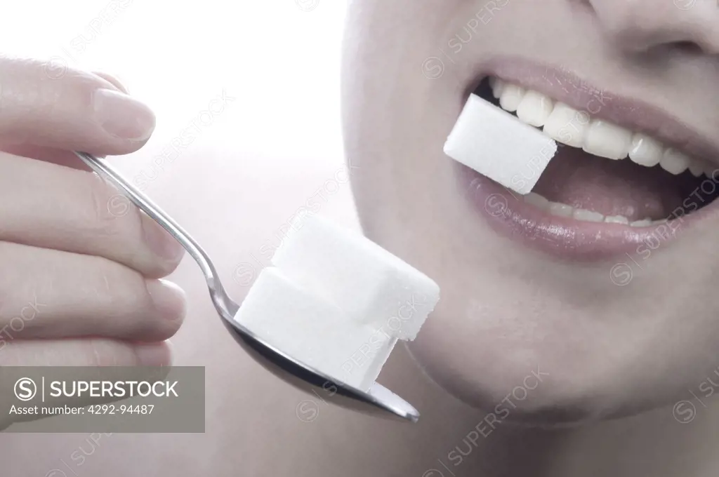 Woman eating sugar Cube