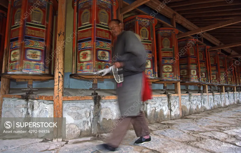 Eastern Tibet, turning the payer drum with auspicious symbol and mantras