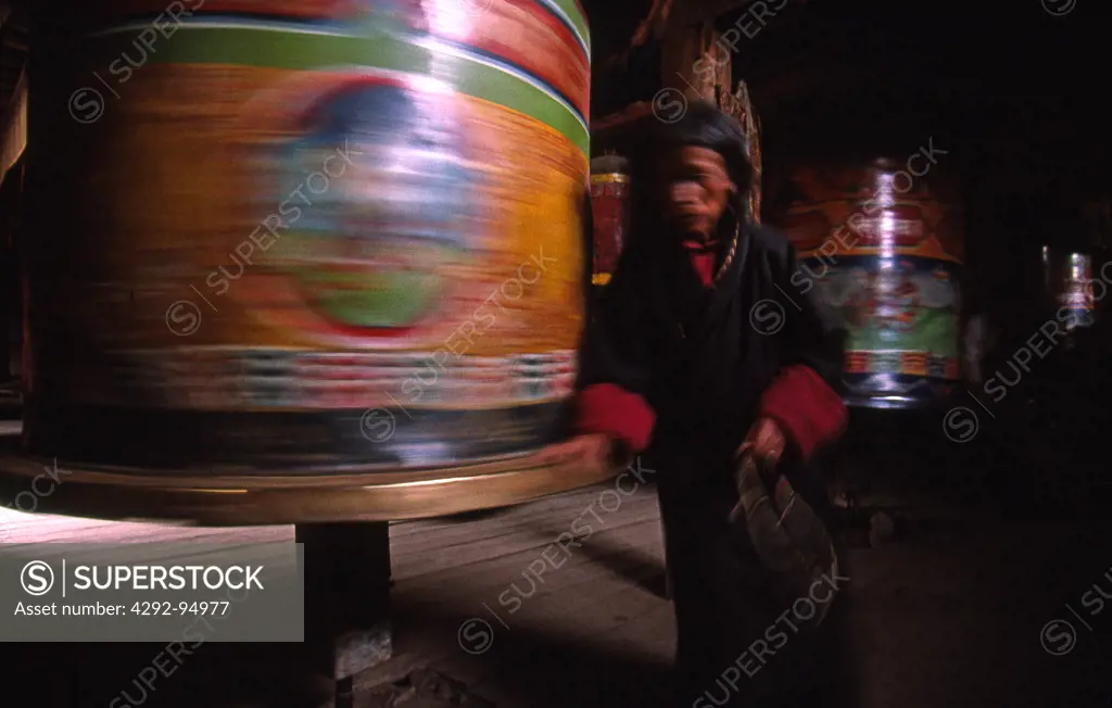 Eastern Tibet, turning the prayer drum with auspicious symbol and mantras