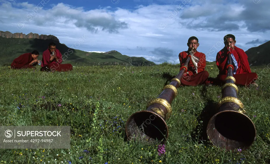 Eastern Tibet, Langmusi, monks playing long trumpets