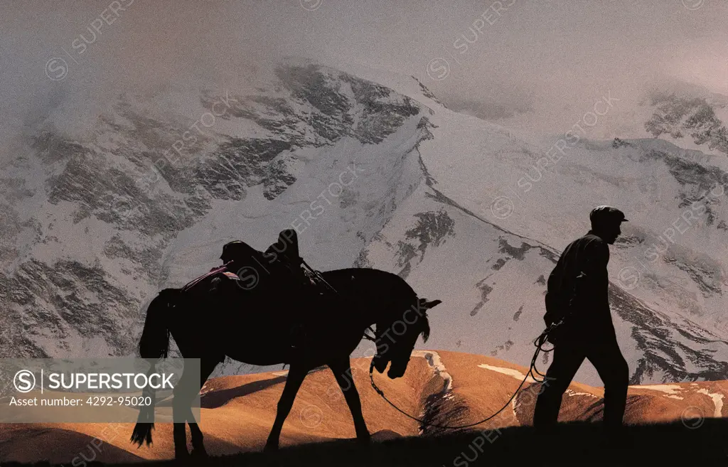 China, Xinjiang province, horseman walking in Pamir mountain range