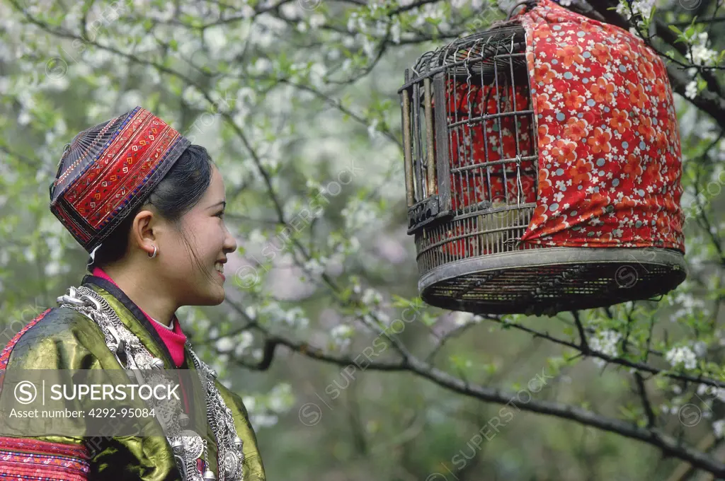 China - Guizhou province - Miao girl enjoy a bird song
